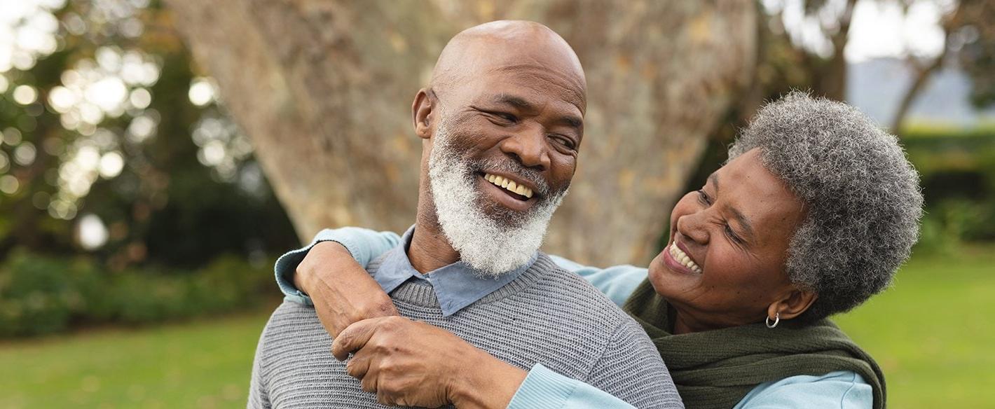 Woman with her arms around her husband